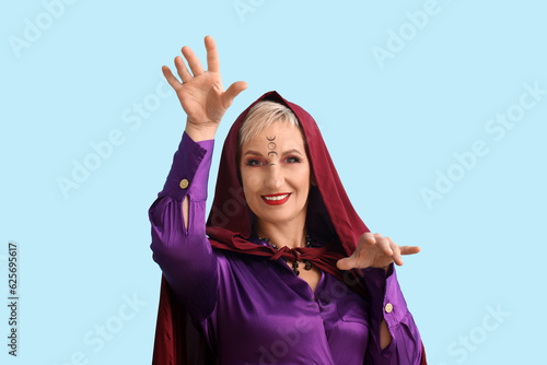 Mature witch on blue backgr...