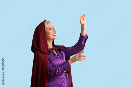 Mature witch on blue backgr...