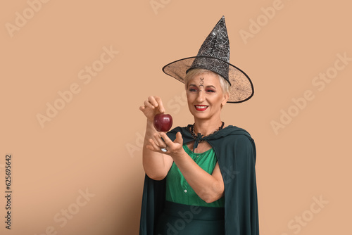 Mature witch with apple on ...