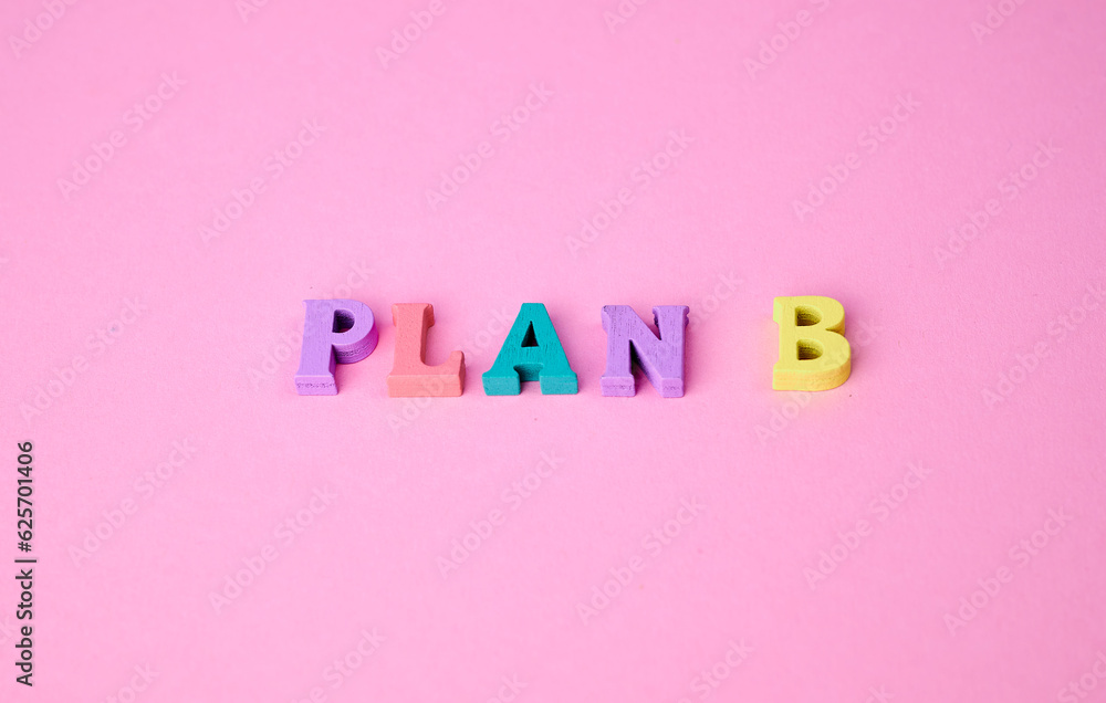 the expression plan B laid with colorful wooden letters on pink background the expression plan B laid with colorful wooden letters on pink background