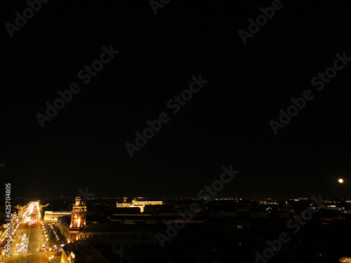 Aerial, up view of the bright Nevski street and Kazan Cathedral and House of the Singer company in the historical city of St. Petersburg at light night 