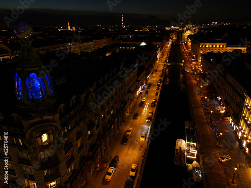 Aerial view of the bright Nevski street and Kazan Cathedral and House of the Singer company in the historical city of St. Petersburg at night 