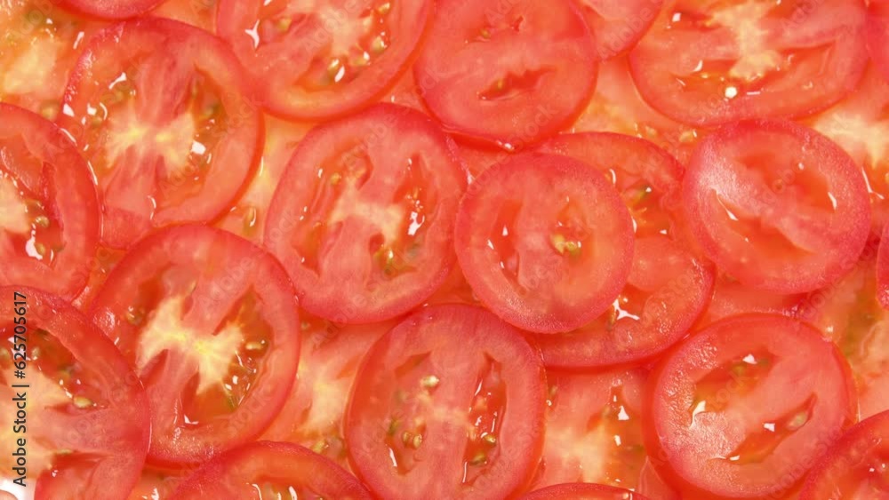 Sliced fresh tomatoes like carpaccio rotate as background. Preparations for pizza or vegetable salad. Tomato slices close up Sliced fresh tomatoes like carpaccio rotate as background. Preparations for pizza or vegetable salad. Tomato slices close up