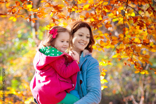 Mother and kid in autumn. Fall outdoor family fun.
