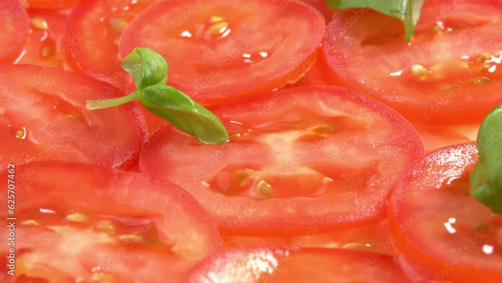 Sliced fresh tomatoes with fresh basil leaves like tomato carpaccio rotate as background. Preparations for pizza or vegetable salad. Tomato slices close up Sliced fresh tomatoes with fresh basil leaves like tomato carpaccio rotate as background. Preparations for pizza or vegetable salad. Tomato slices close up