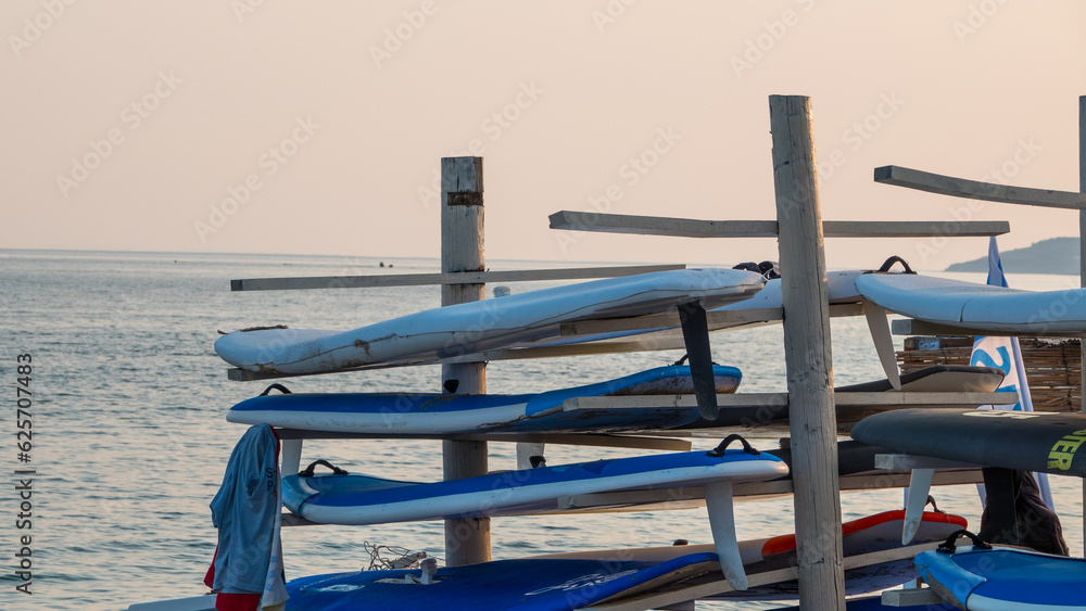 Surfboards stacked on top of each other in the evening on Gokceada Aydincik (Kefalos) beach. Canakkale, Turkey