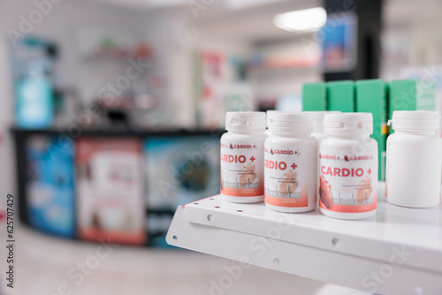 Selective focus of pills packages standing on shelves in empty pharmacy store, prepared for clients to buy. Drugstore space filled with pharmaceutical products and supplement boxes