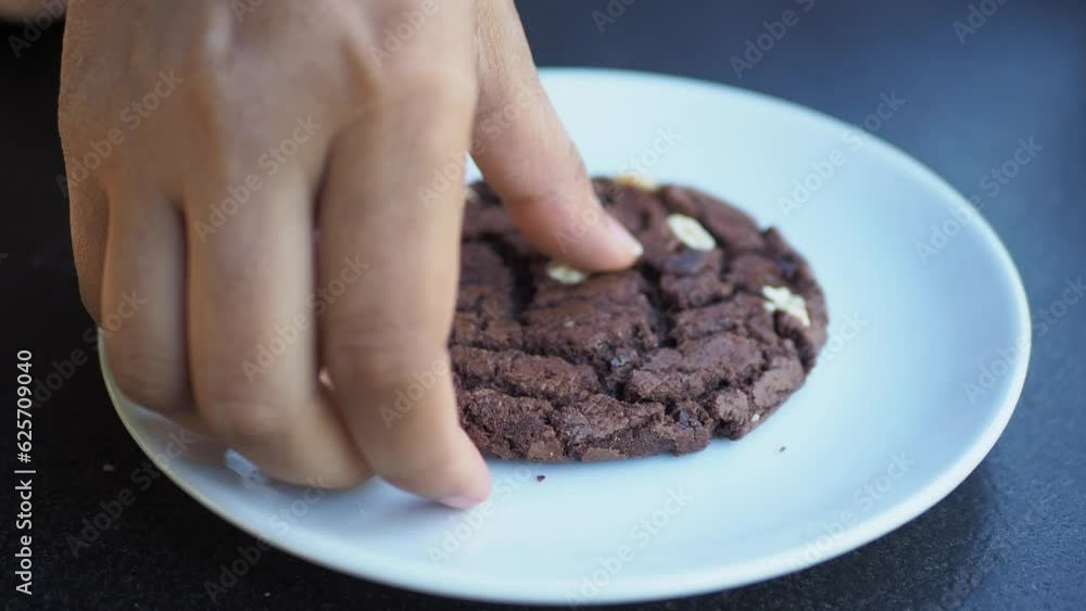women hand pick a chocolate cookies women hand pick a chocolate cookies