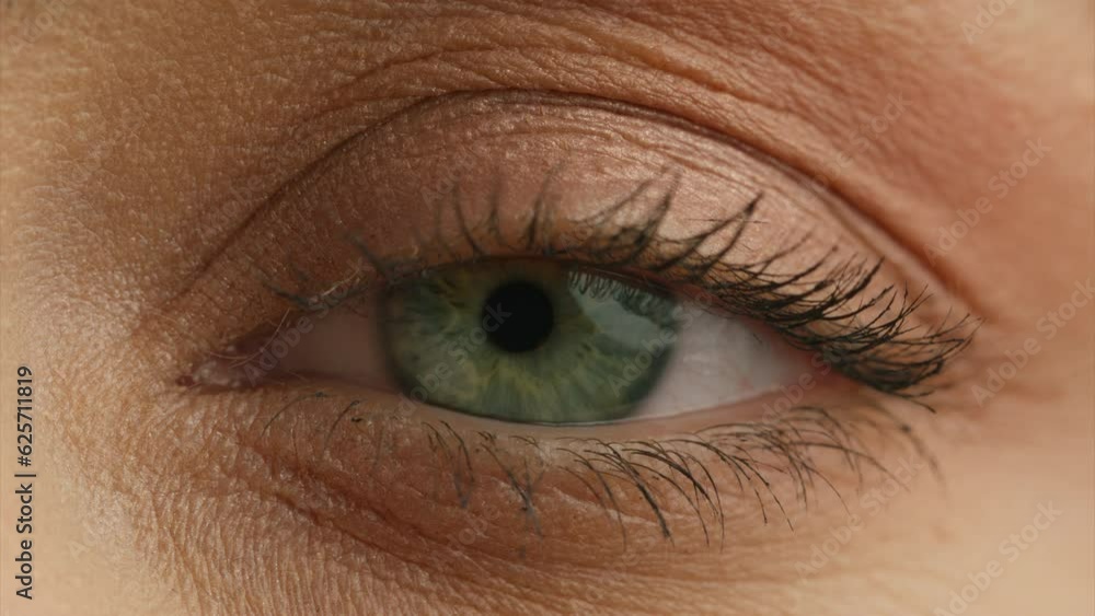 Macro close up shot of female human eye. Young woman with incredible light green eyes. Close up shot of eye opening with beautiful teal iris. Healthy eyesight concept. Front view 4K RED camera footage Macro close up shot of female human eye. Young woman with incredible light green eyes. Close up shot of eye opening with beautiful teal iris. Healthy eyesight concept. Front view 4K RED camera footage