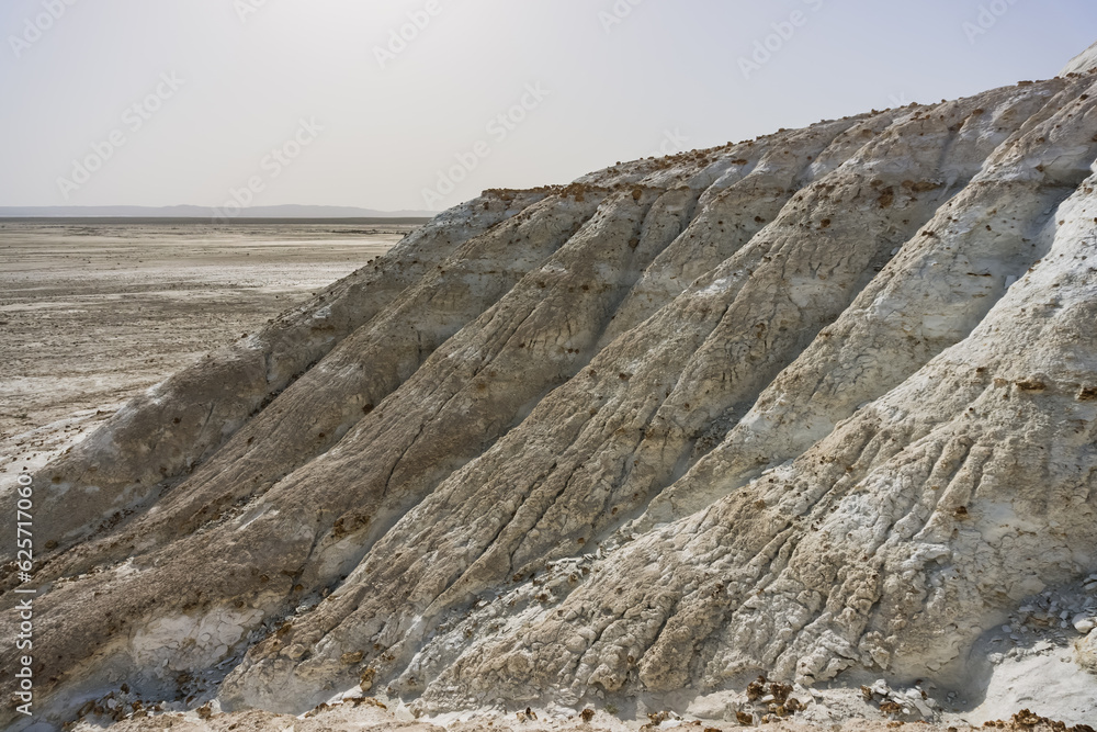 The slope of Mount Bokty from limestone and chalk deposits in the Kazakh steppe, the relief of the hillside, ditches and gullies washed out by water The slope of Mount Bokty from limestone and chalk deposits in the Kazakh steppe, the relief of the hillside, ditches and gullies washed out by water