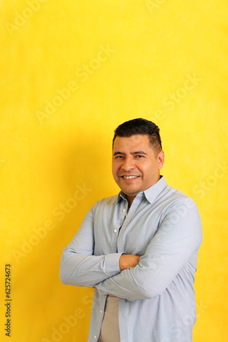 Happy and successful 40-year-old dark-haired Latino man smiles and poses for the camera relaxed and calm