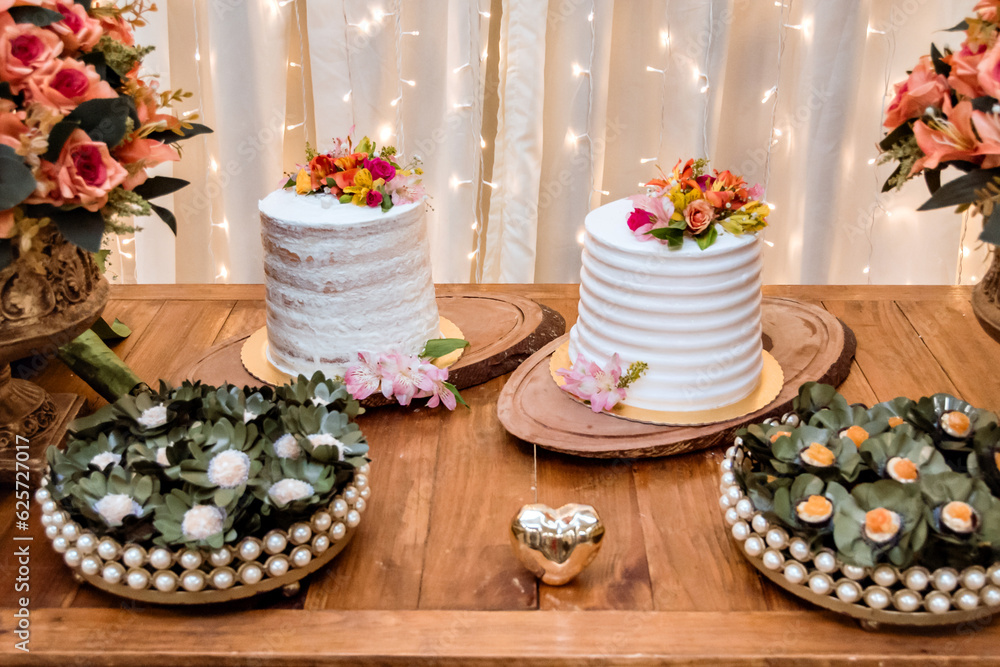 two wedding cakes decorated with orange flowers on top
