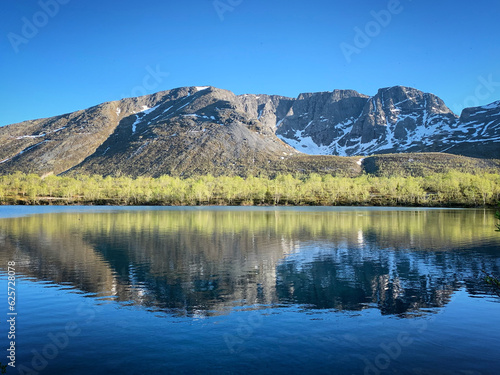 Reflection of the mountain in lake near Kirovsk, Russia, June 2019