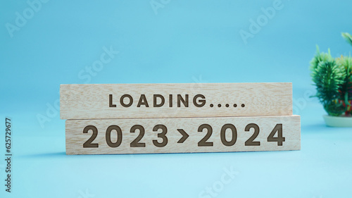 2024 New Year Loading. Loading bar with wooden blocks 2024 on blue background. Start the new year 2024 with a goal plan  goal concept  action plan  strategy  and new year business vision.