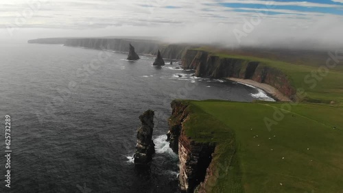 Aerial shot of the coast line of Duncansby Head in the Scottish Highlands. Drone shot of dramatic sea stacks at Duncansby Head near John O' Groats in Scotland. photo