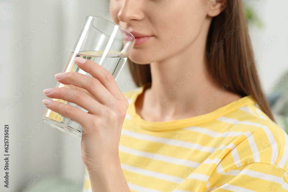 Healthy habit. Closeup of woman drinking fresh water from glass indoors Healthy habit. Closeup of woman drinking fresh water from glass indoors