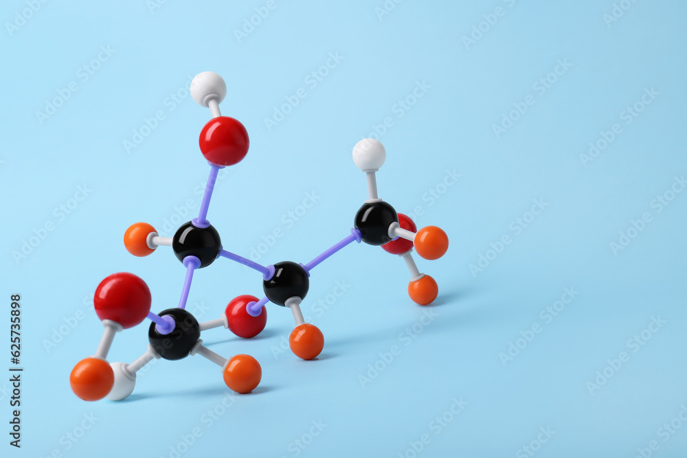 Molecule of sugar on light blue background, space for text. Chemical model