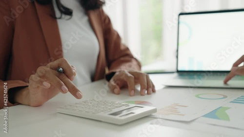 Close-up. Hand woman asian using calculator to company finance result and budget on digital tablet