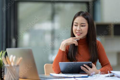 Free Download Asian businesswoman using tablet, laptop at modern office to research, record, to make account analysis report, real estate investment data. Division of paperwork. Finance and tax system concept. - GFXLoad