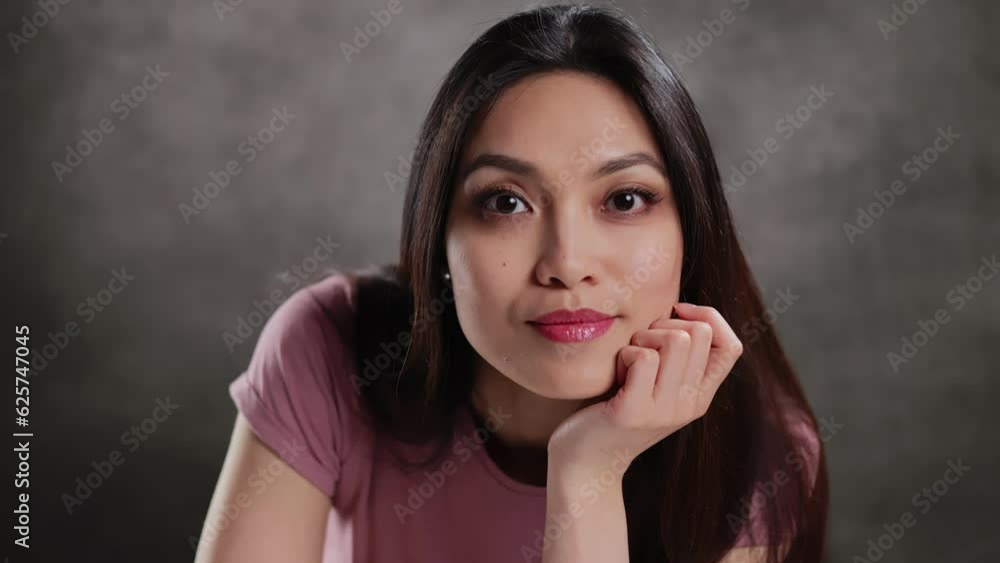 Young Asian woman in a studio doing some gestures for a photo shooting - extreme slow motion Young Asian woman in a studio doing some gestures for a photo shooting - extreme slow motion