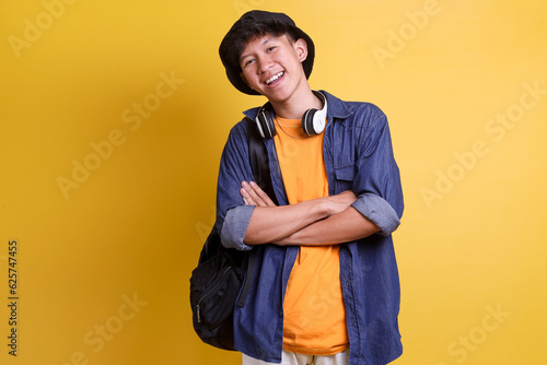 Bild auf Leinwand Confident young man crossing his arms, looking at camera and smiling