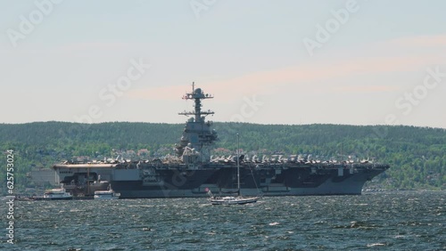 Military Ship USS Gerald Ford With Boats Sailing In Oslo Fjord In Norway. wide photo