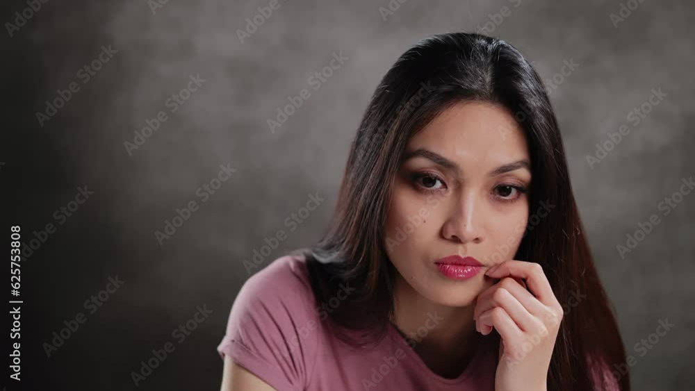 Young Asian woman in a studio doing some gestures for a photo shooting - extreme slow motion Young Asian woman in a studio doing some gestures for a photo shooting - extreme slow motion
