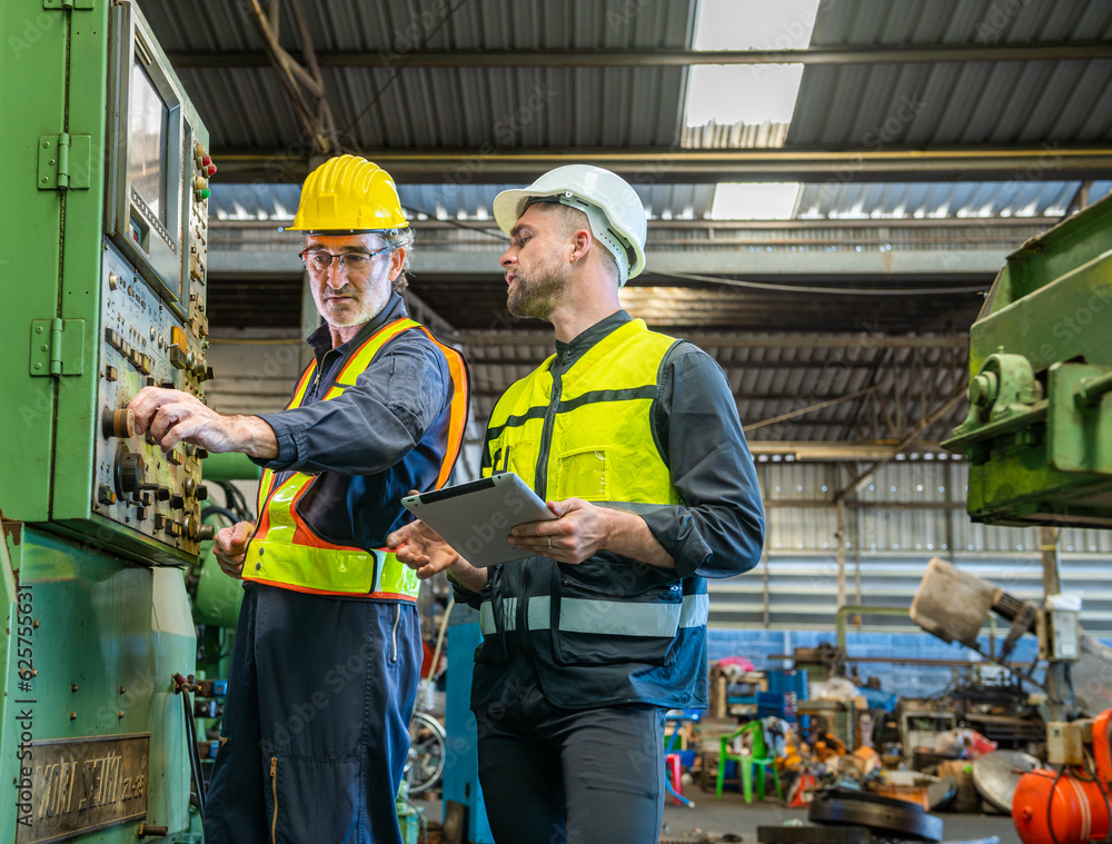 Two professional engineer worker technician assistant in helmet inspection check old machine construction factory with colleague manager. check old machinery production construction operating Two professional engineer worker technician assistant in helmet inspection check old machine construction factory with colleague manager. check old machinery production construction operating