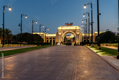 View at sunset to the decoratively decorated alley  and decorative arch in front of the Zaabeel Palace in the Dubai city, United Arab Emirates photo