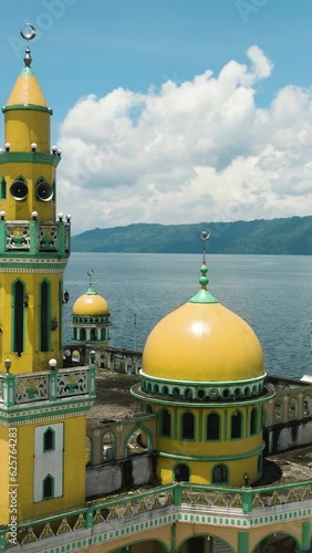 Tropical Landscape with Linuk Masjid mosque and Lake Lanao in Lanao del Sur. Mindanao, Philippines. Vertical video. photo