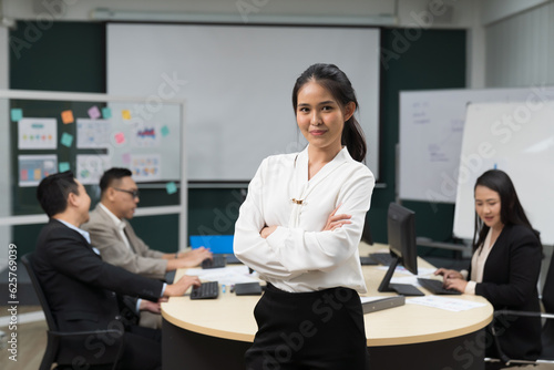 Asian, business woman and office. Young Asian business woman working and standing with crossed arms in meeting room in office
