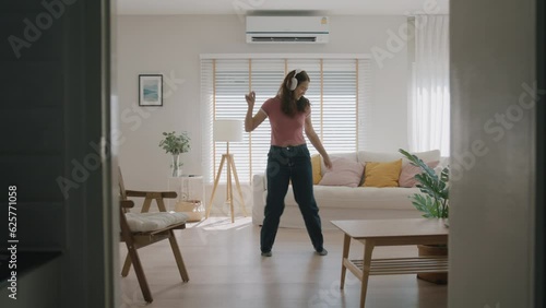 Young asia people Gen Z woman relax happy fun moving in new home. Humor laugh smile listen music funny dance crazy joy playing at cozy sofa life balance in youth culture. Enjoy weekend staying at home