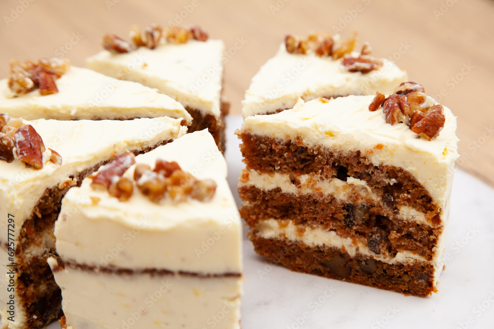 Classic carrot cake with cream cheese frosting, pecan, walnut and raisin Classic carrot cake with cream cheese frosting, pecan, walnut and raisin