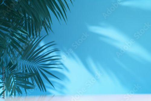 Blurred shadow from palm leaves on the blue wall  Minimal abstract background for product presentation  Spring and summer