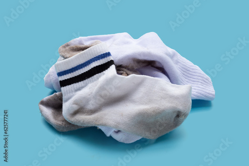 Photography Dirty white socks on blue background.