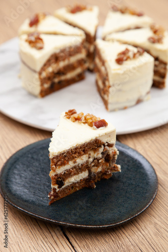 Classic carrot cake with cream cheese frosting, pecan, walnut and raisin