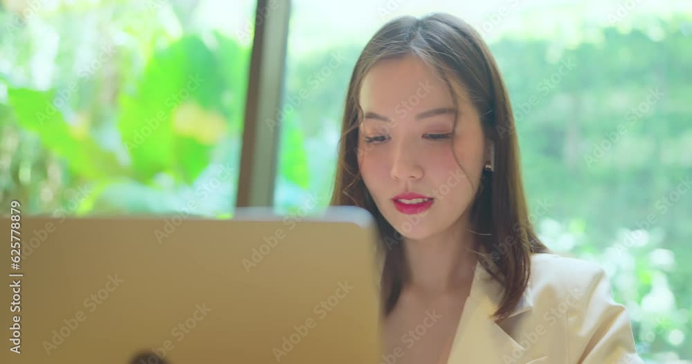 Asian business woman have online meeting with team. She using computer to work in co-working space. Asian business woman have online meeting with team. She using computer to work in co-working space.
