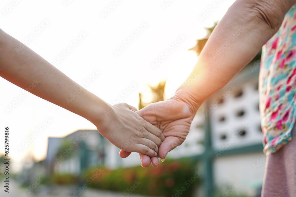 parent holds the hand of a small child parent holds the hand of a small child