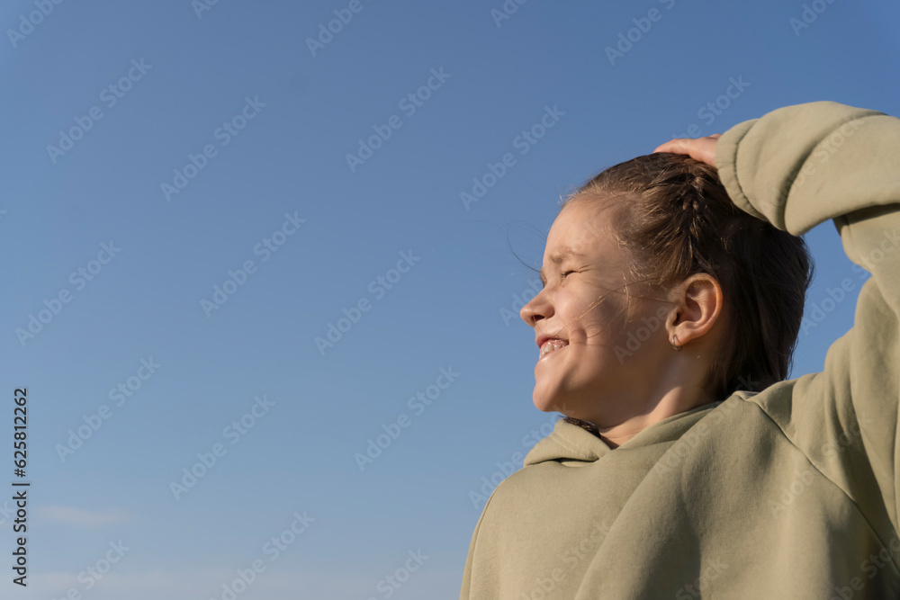 Happy child against blue sky background. Happy child against blue sky background.