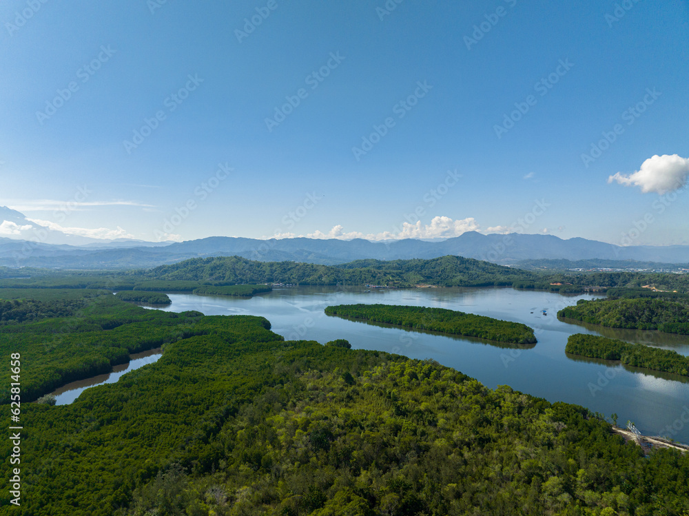 Bay with mangroves against the backdrop of mountains with tropical vegetation. Borneo, Malaysia.