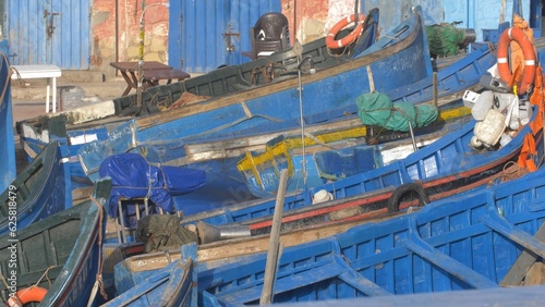 Fisherman Working in Fishing Port Cleaning Boats in Small Village in Morocco