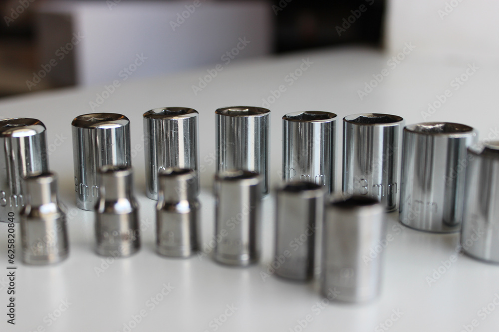 Ratchet Drive Sockets For Hex Nuts Arranged By Size On White Workbench
Ratchet Drive Sockets For Hex Nuts Arranged By Size On White Workbench