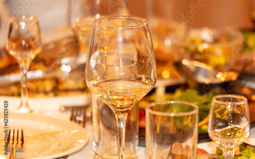 Glasses of white wine on the table ready for a romantic dinner