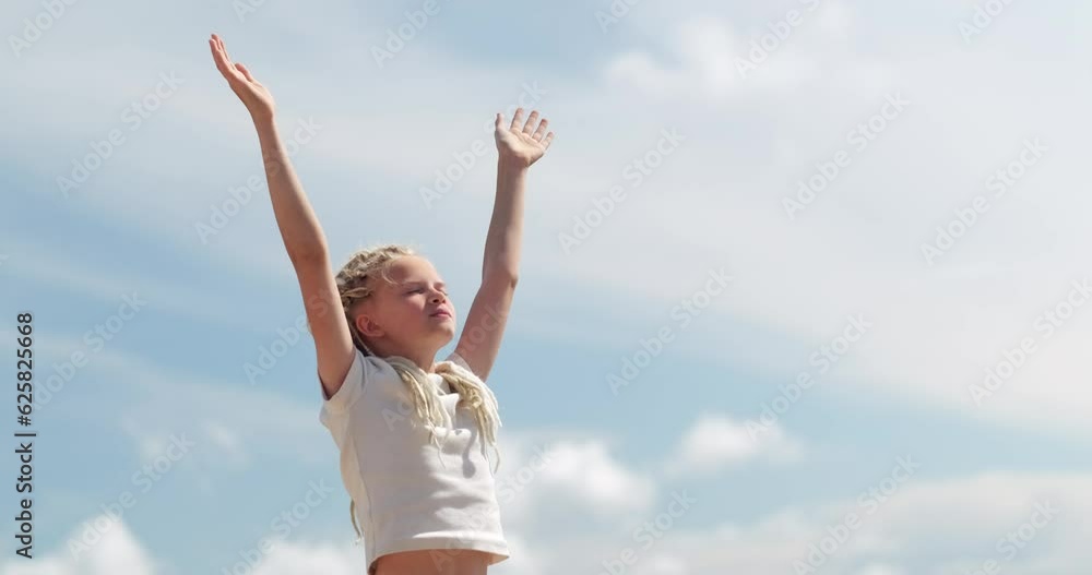 Relaxed girl breathing fresh air raising arms over blue sky at summer. Dreaming, freedom and traveling concept. Relaxed girl breathing fresh air raising arms over blue sky at summer. Dreaming, freedom and traveling concept.