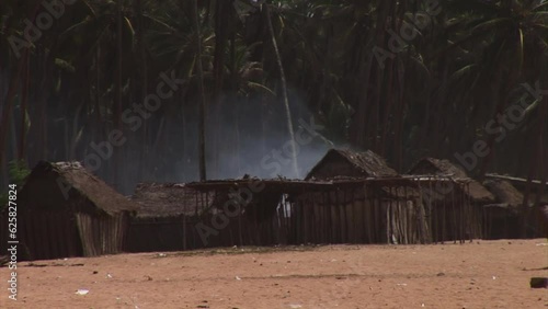 Smoke coning from a fishing village on the beach in Nigeria. photo