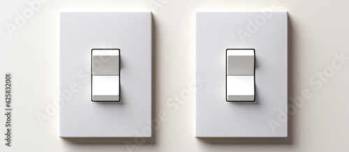 Photo of a pair of light switches on a clean white wall with copy space