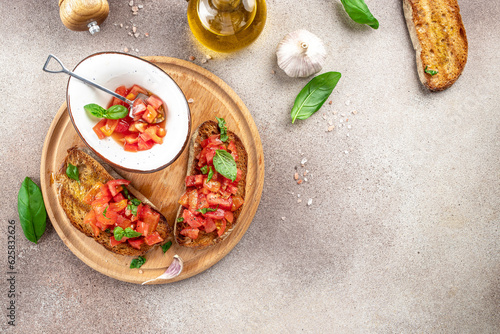tasty Italian bruschetta with toasted savory bread topped with tomato and herbs garnished. banner, menu, recipe place for text, top view