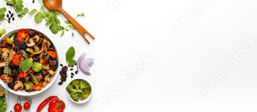 Photo of a colorful bowl of fresh vegetables with a spoon on the side with copy space