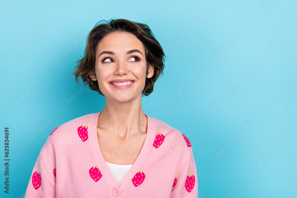 Photo of positive pretty cute girl wearing trendy clothes watching empty space interesting proposition isolated on blue color background Photo of positive pretty cute girl wearing trendy clothes watching empty space interesting proposition isolated on blue color background