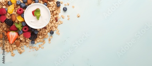 Photo of a colorful bowl of cereal topped with fresh fruits with copy space